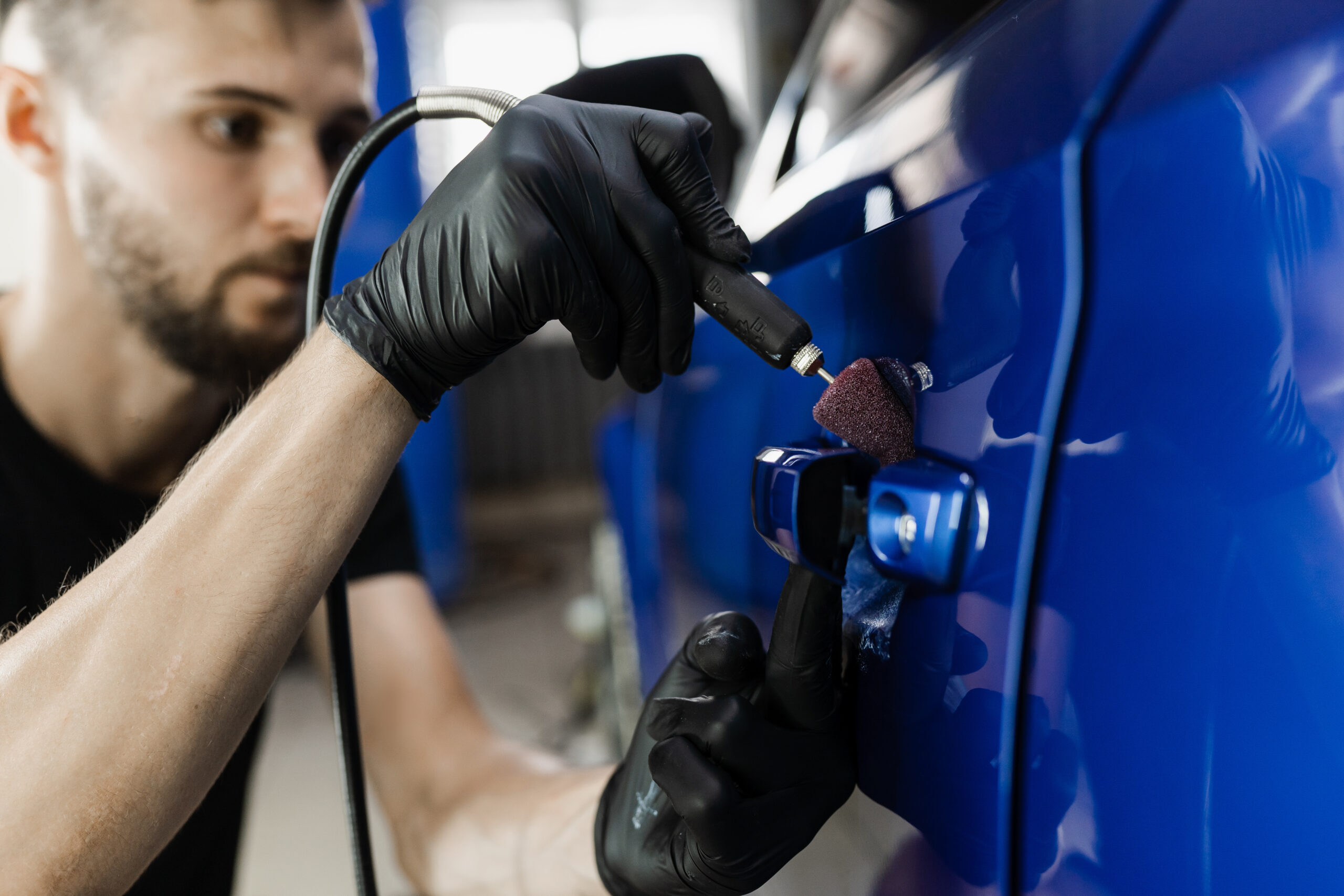 car-handle-polishing-with-orbital-polisher-remove-scratches-handles-car-worker-detailing-auto-service-making-final-polishing-car-scaled.jpg