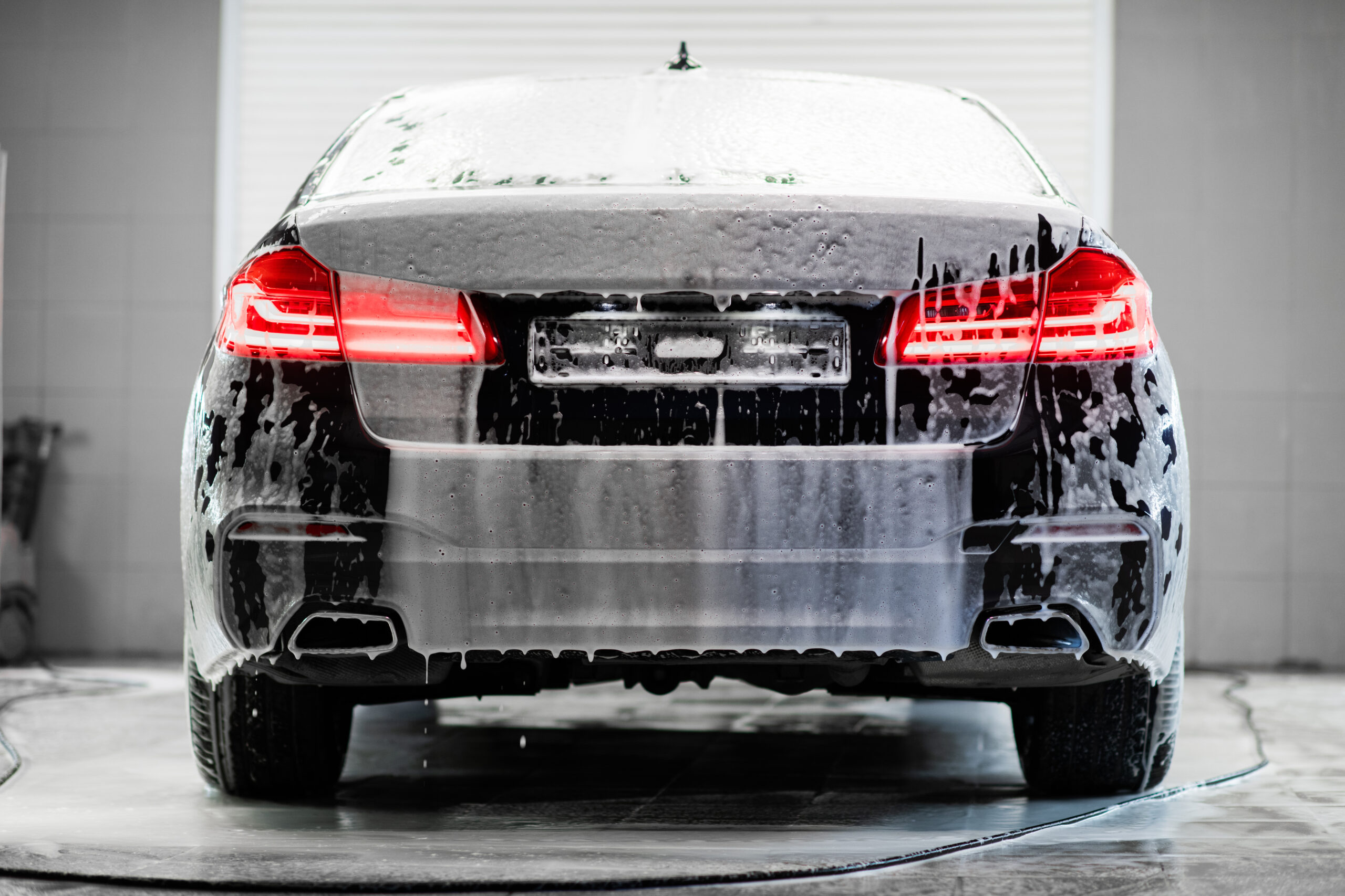car-with-turned-backlights-standing-car-wash-service-covered-with-foam-1-scaled-1.jpg