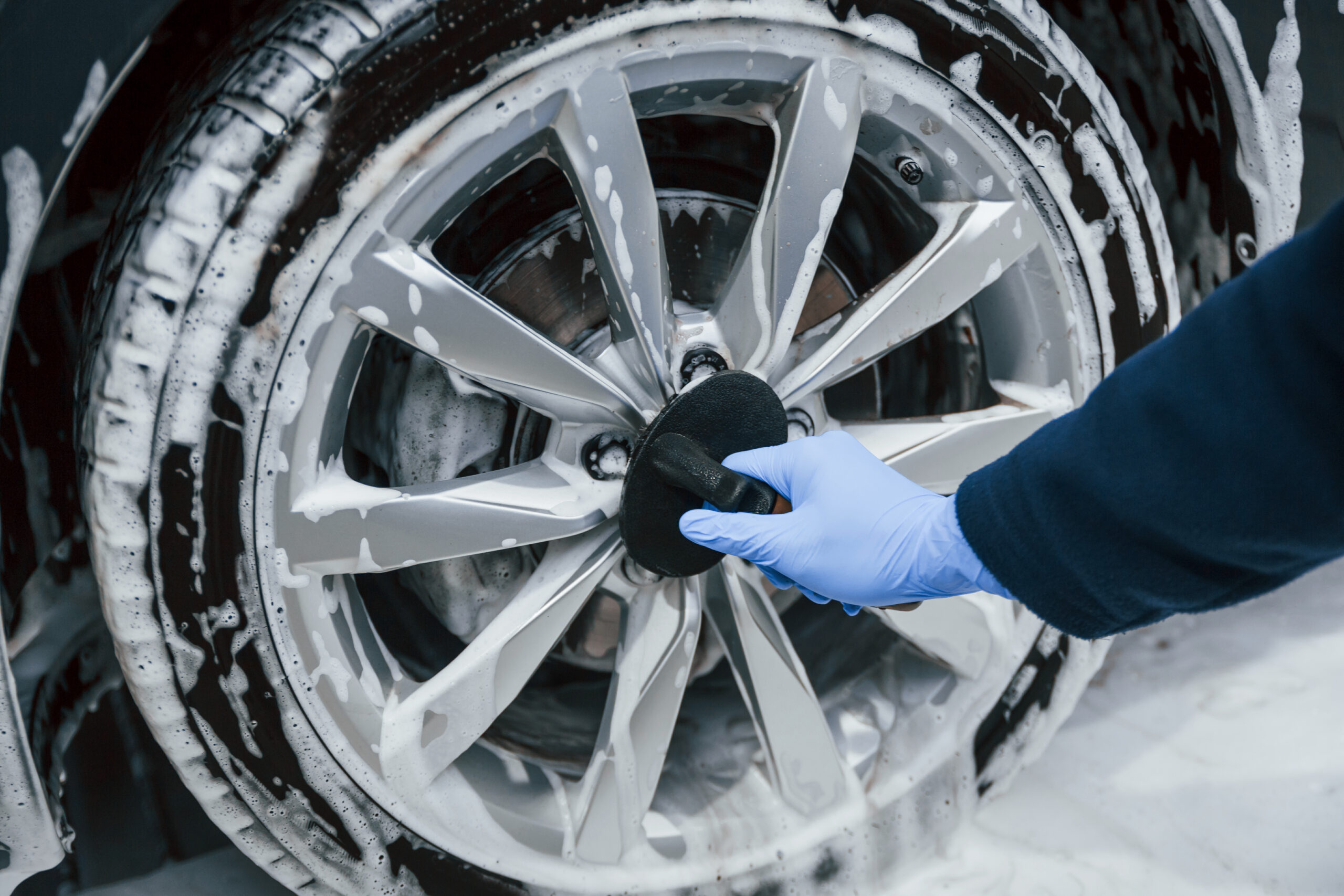 male-worker-uniform-washing-new-modern-car-that-covered-with-soap-conception-service-scaled.jpg